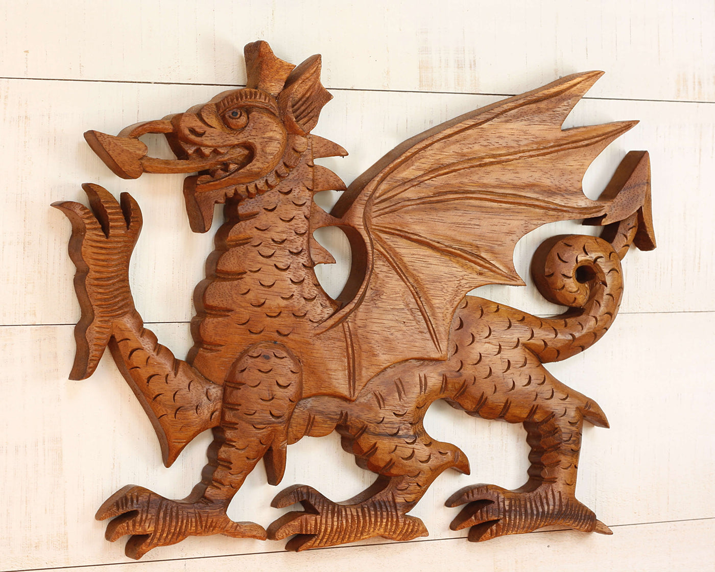 Wooden dragon sculpture on a light wooden background