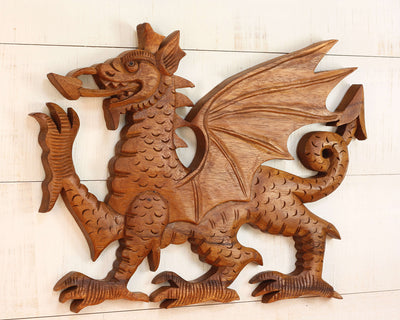 Wooden dragon sculpture on a light wooden background