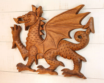 Wooden dragon sculpture on a light wooden background