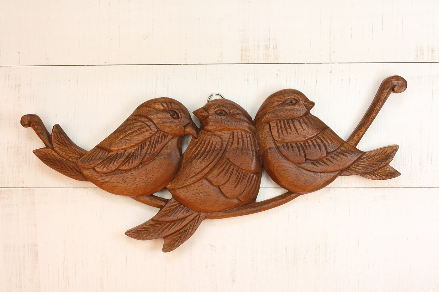 Hand carved wood wall panel featuring three birds on a branch