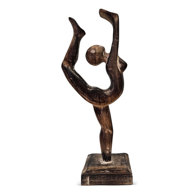 Wooden sculpture of a figure in a dynamic pose on a white background