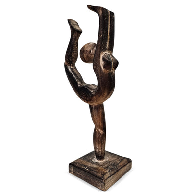 Wooden sculpture of a dancer on a white background
