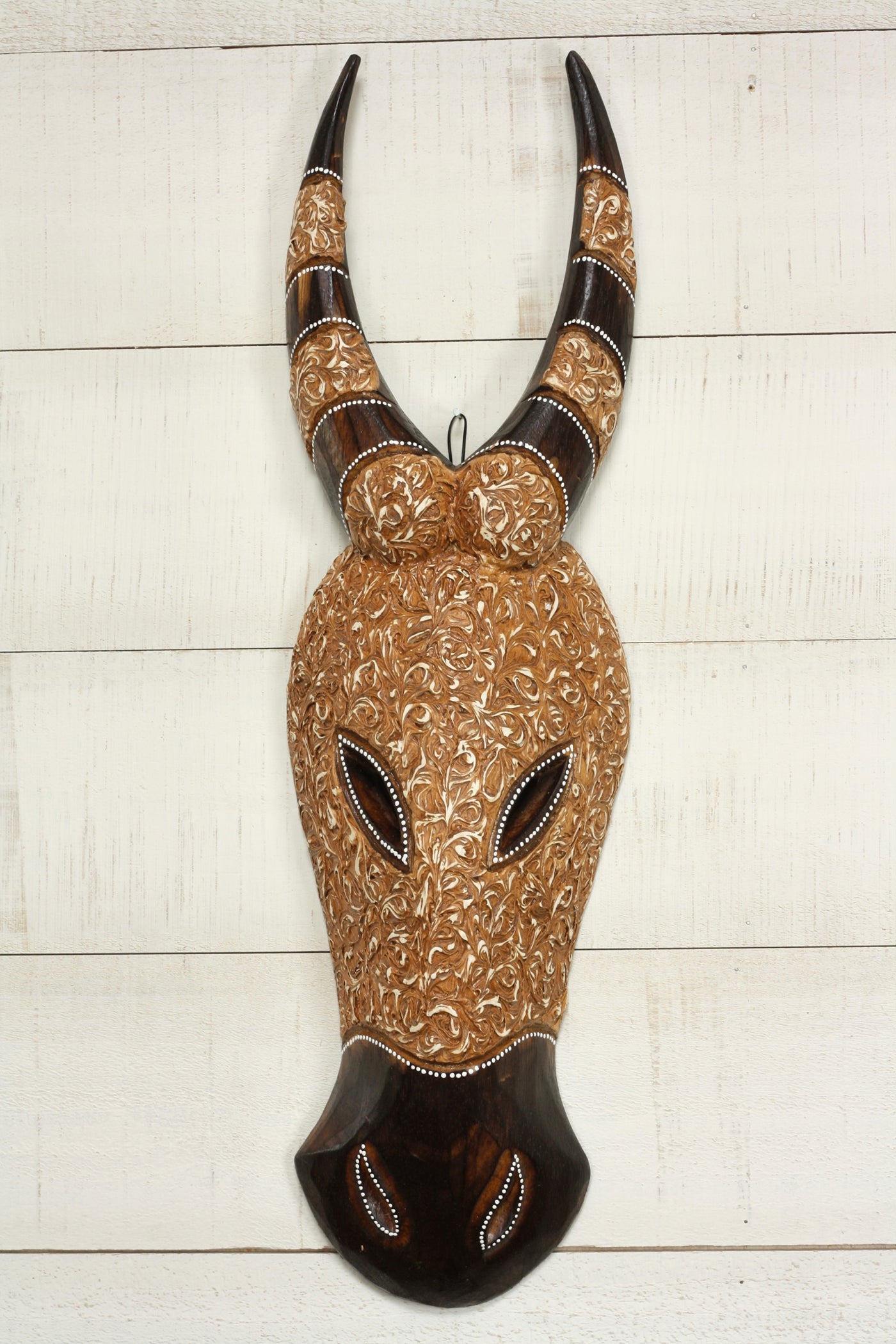 Hand carved wood buffalo wall mask with floral patterns and curved horns