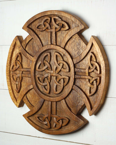 Wooden cross with intricate carvings on a white background