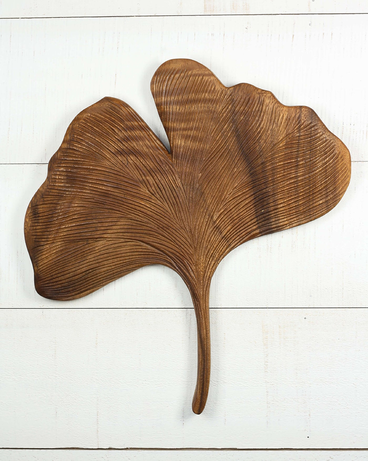Hand carved wooden ginkgo leaf wall sculpture with detailed veins.