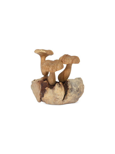 Decorative figurine of mushrooms on a rock with a white background