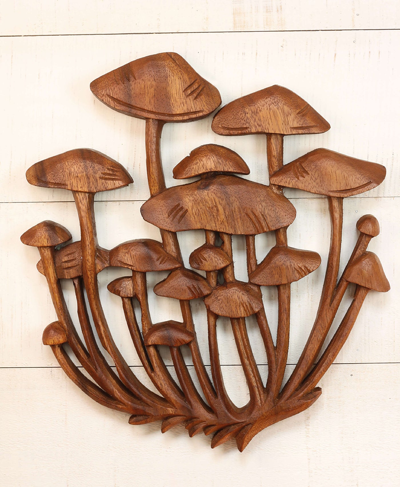 Hand carved wood wall panel featuring a cluster of mushrooms