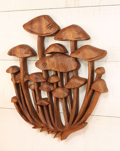 Wooden wall art of mushrooms on a light wooden background