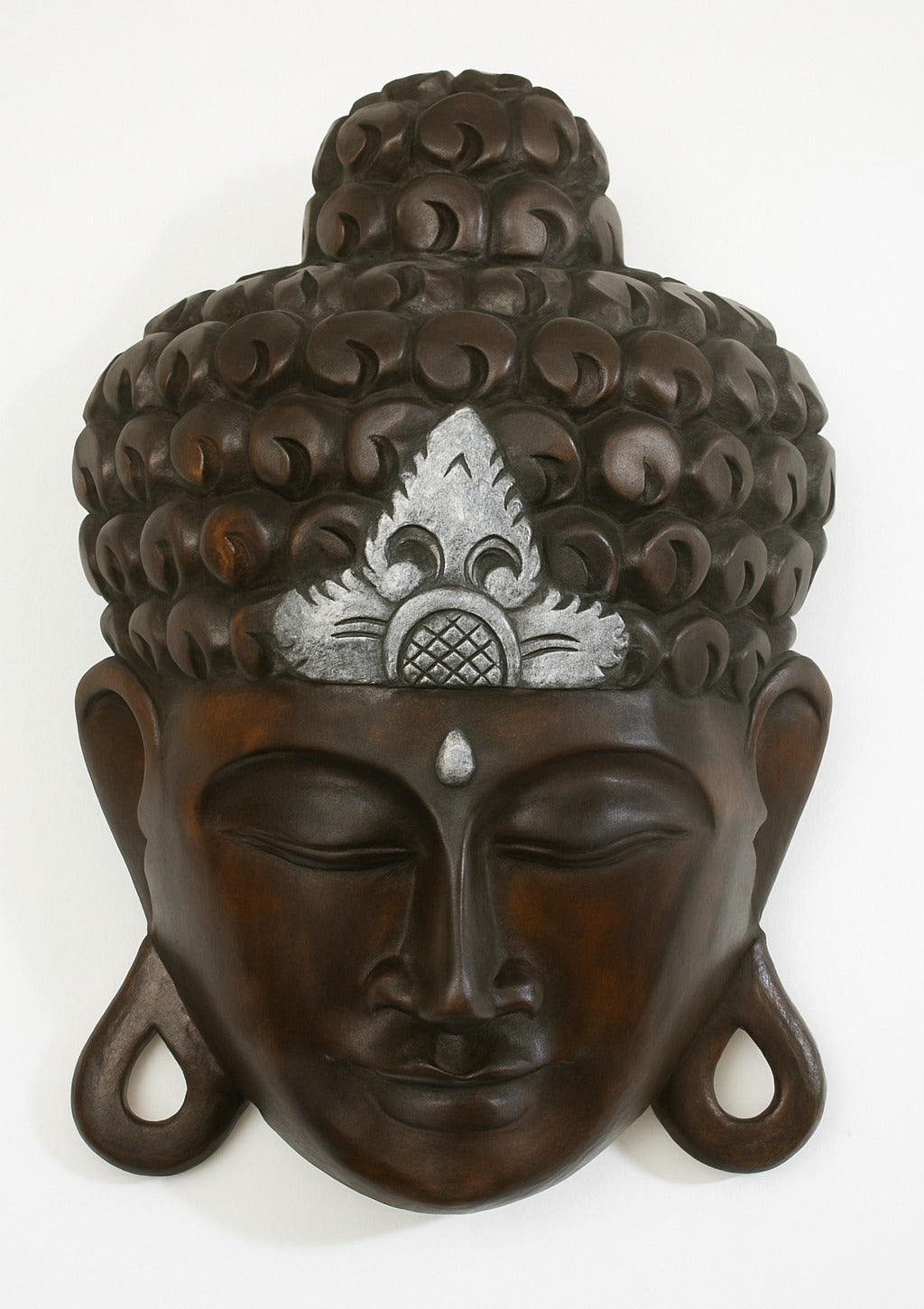 Bring tranquility to your home with this 12" hand carved wooden Buddha wall mask, black with silver crown. Perfect as spiritual décor, gift, or wall hanging.