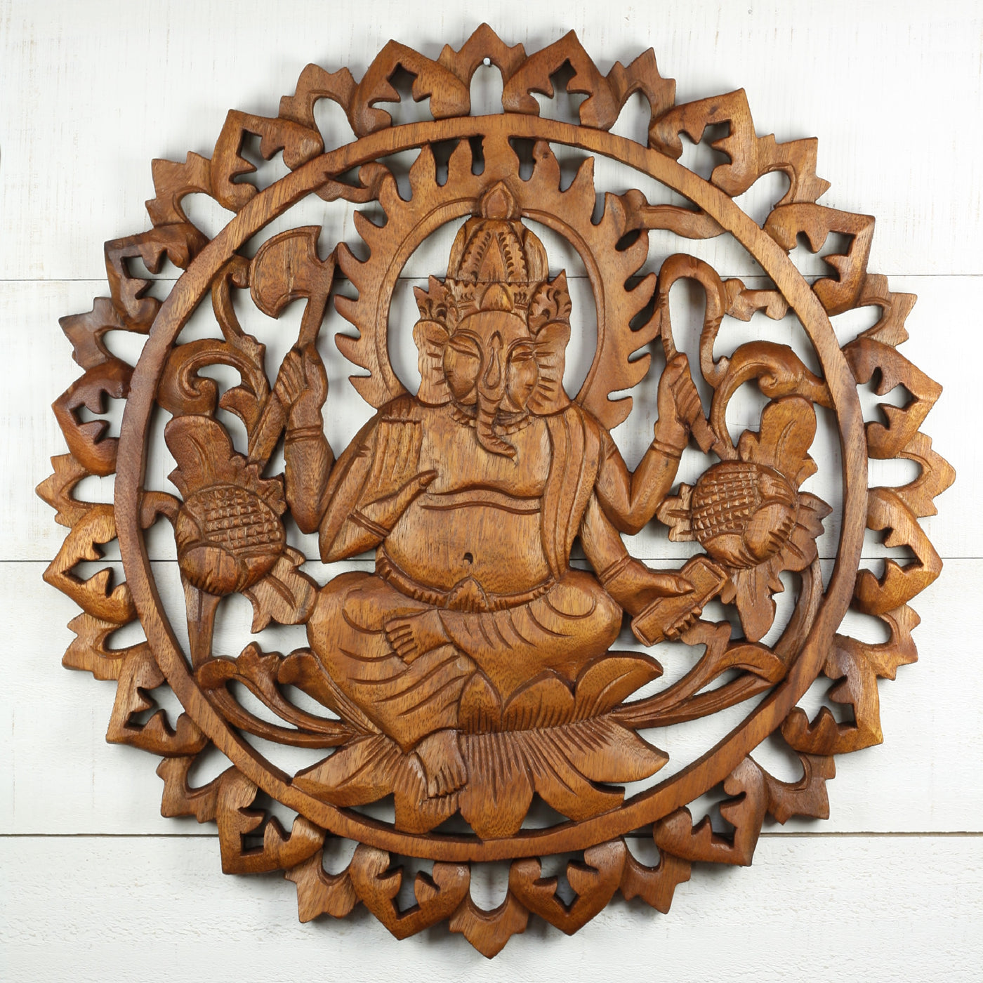 Hand carved wooden wall panel of Ganesha sitting on lotus with intricate mandala frame