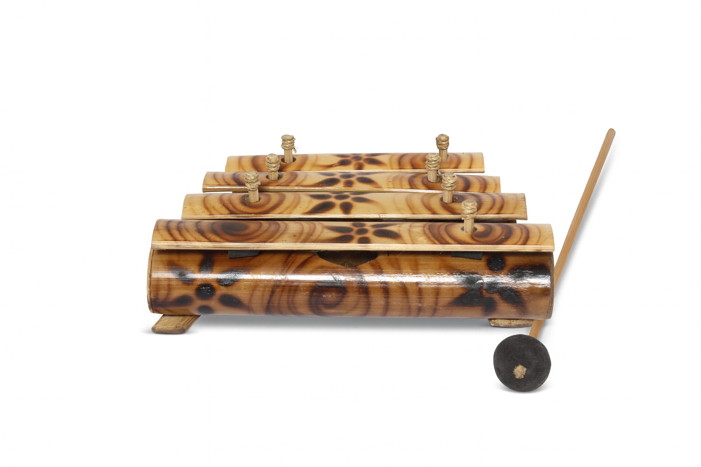 Wooden xylophone with four bars and a beater on a white background